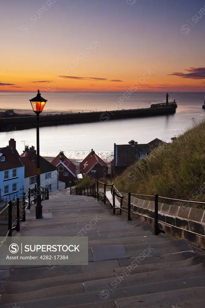England, North Yorkshire, Whitby. View from Whitby's 199 steps over the harbour at sunset.
