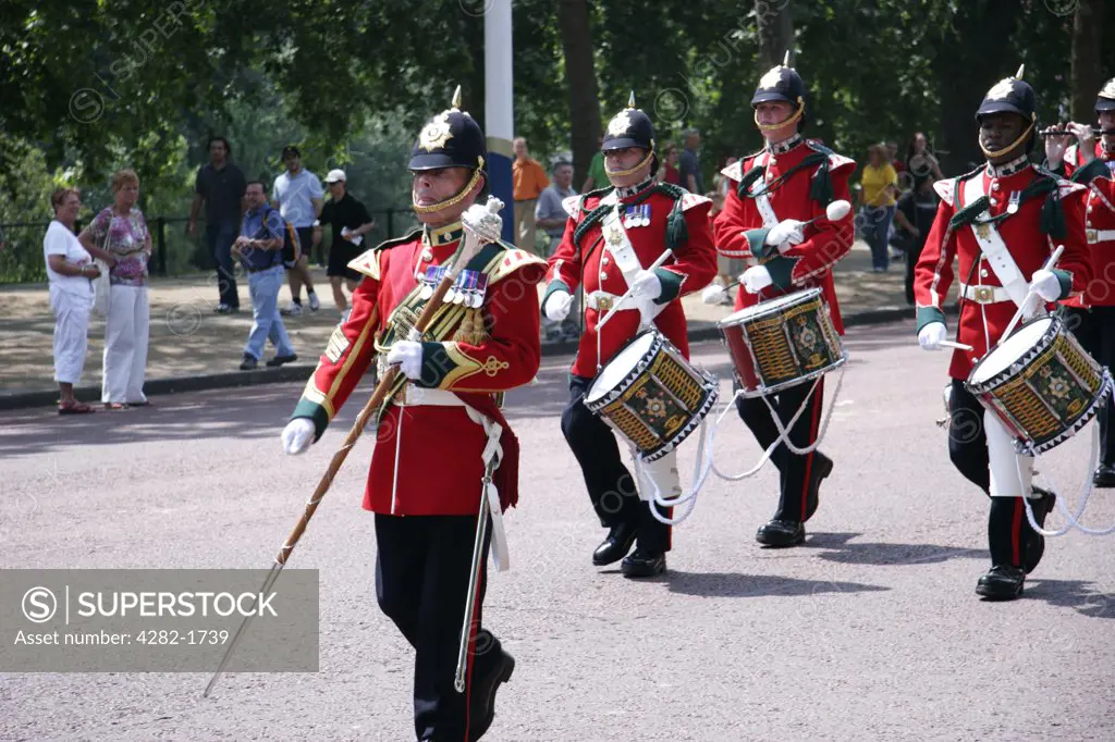 England, London, The Mall. A military band parades down the Mall near to Buckingham Palace.