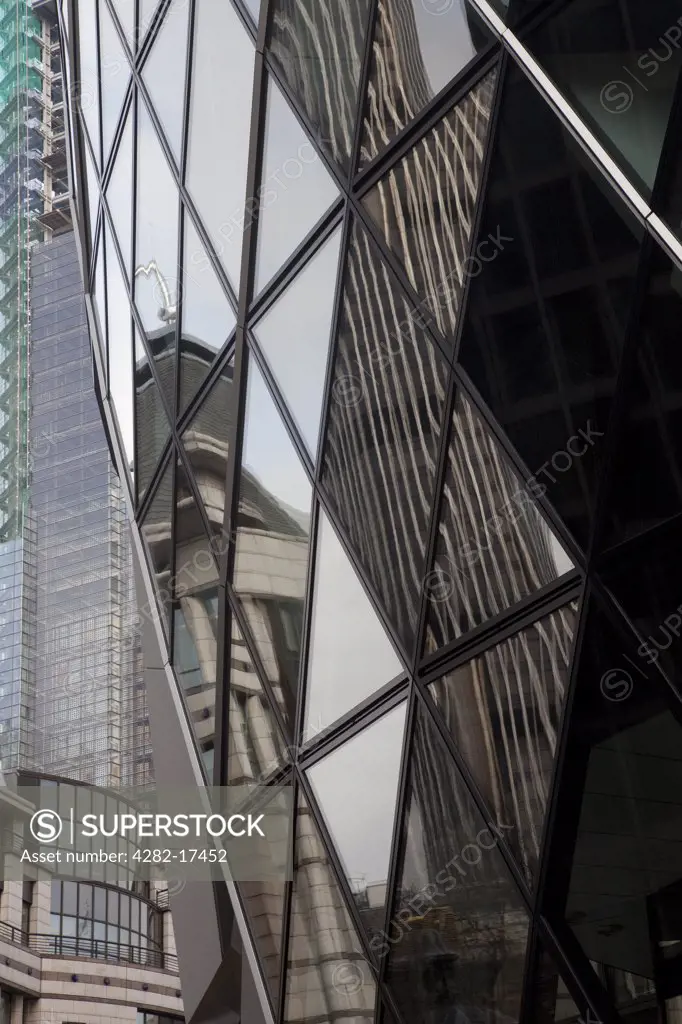 England, London, The City of London. Tower 42, originally named the National Westminster Tower, reflected in the glass exterior of 30 St Mary Axe known as the Gherkin, in the City of London.