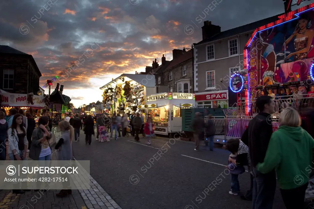 England, North Yorkshire, Stokesley. People enjoying Stokesley fair, held in the High Street every September.