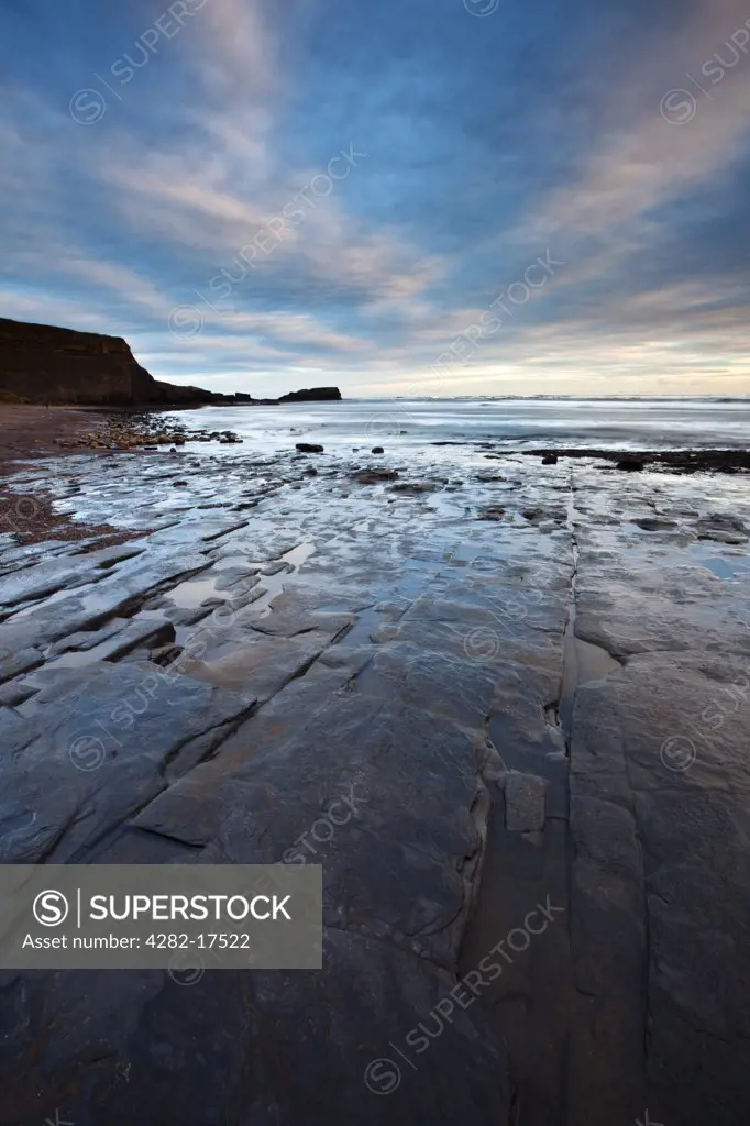 England, North Yorkshire, Saltwick Bay. Shale pavement at low tide in Saltwick Bay near Whitby on the North Yorkshire Coast.