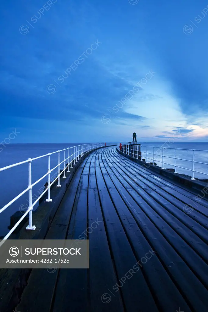 England, North Yorkshire, Whitby. Whitby West Pier Light at the end of the West Pier at dawn.