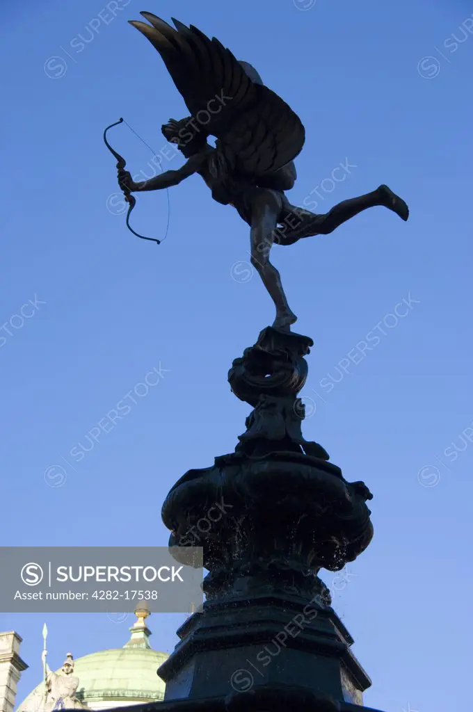 England, London, Piccadilly Circus. Silhouette of the statue of Eros on the Shaftesbury memorial fountain at Piccadilly Circus in London's West End.
