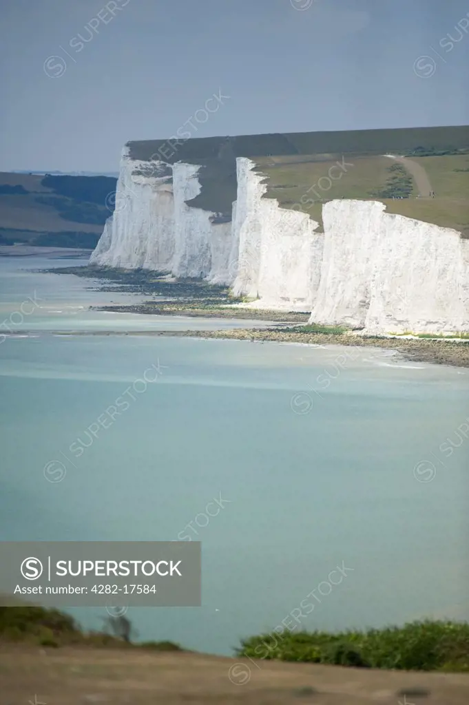 England, East Sussex, Birling Gap. People walking along the cliff tops near Beachy Head at Birling Gap.