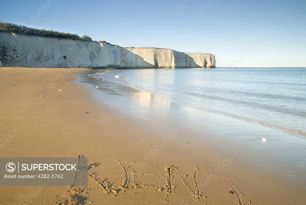England, Kent, Botany Bay. A view along the beach towards a natural hole in the chalk cliff at Botany Bay on the east coast of Kent.