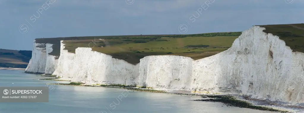 England, East Sussex, Birling Gap. People walking the coastal path on the Seven Sisters at Birling Gap near Beachy Head.