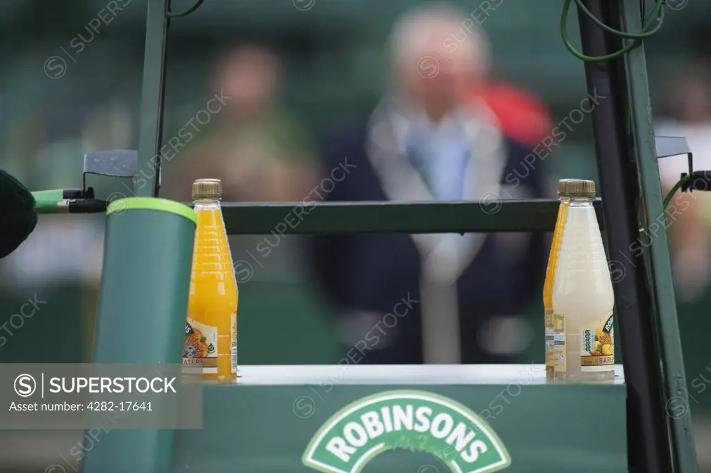 England, London, Wimbledon. Tennis umpire seen through the umpires chair with bottles of Barley water at the Wimbledon lawn tennis championships in London.