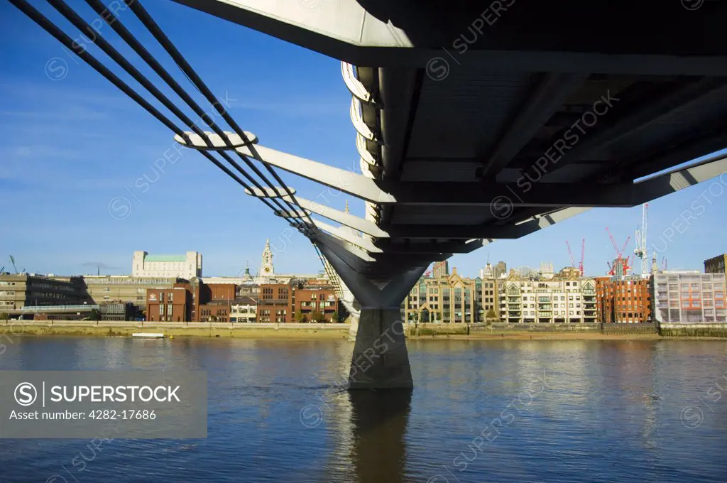 England, London, Bankside. View from under the Millennium footbridge over the River Thames in central London towards the City of London.