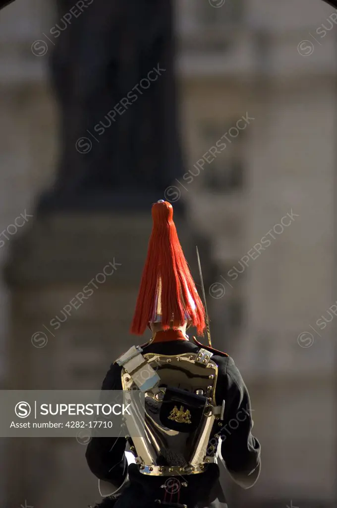 England, London, Whitehall. Rear view of a horse mounted guard in the Blues and Royals regiment on sentry duty in Whitehall, central London.