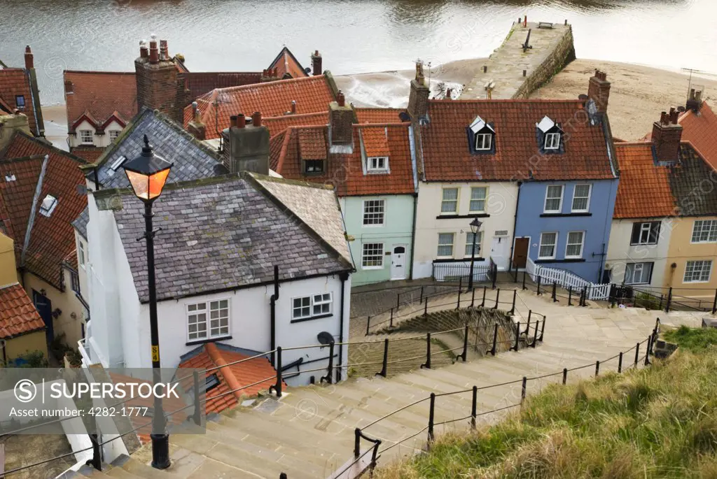 England, North Yorkshire, Whitby. A traditional street light illuminates the 199 steps leading down towards the old town of Whitby.