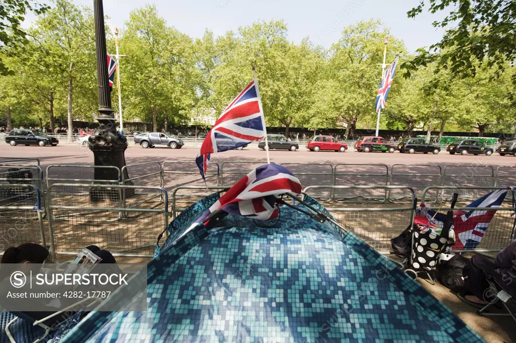 England, London, The Mall. People sitting by their tent pitched on the Mall along the Royal Wedding route, a day before the big event in central London.