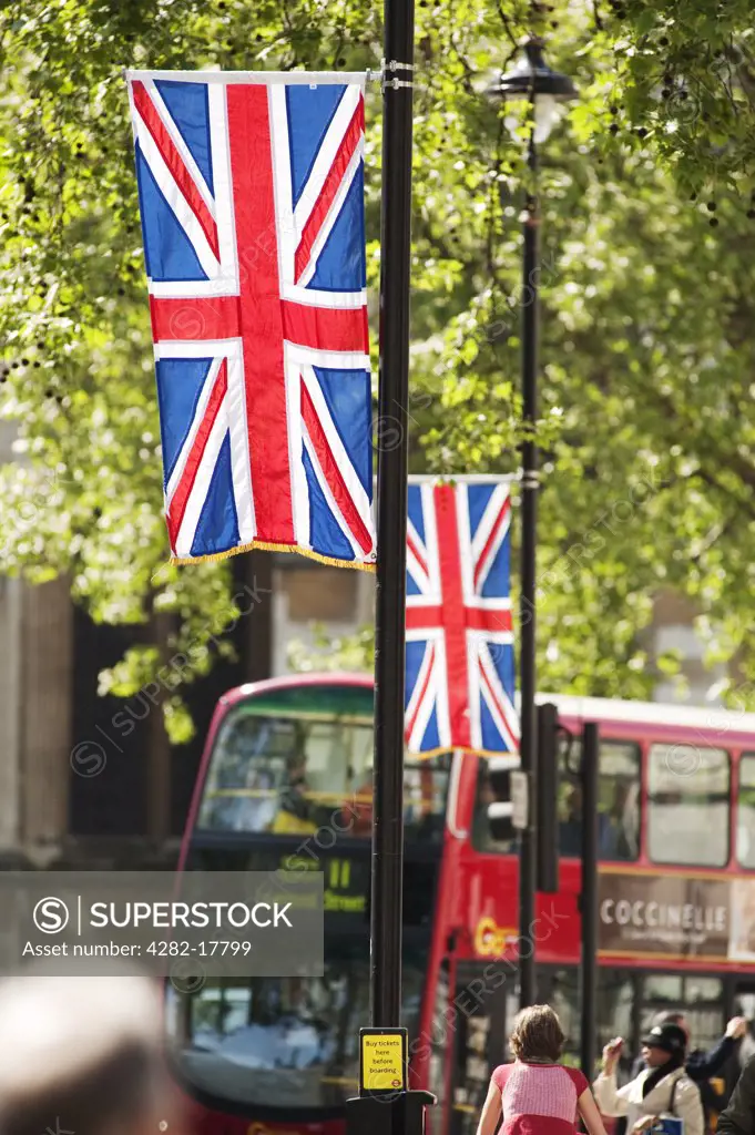 England, London, Whitehall. Union Flags hanging from lampposts on the Royal Wedding route in Whitehall with red bus in the background.