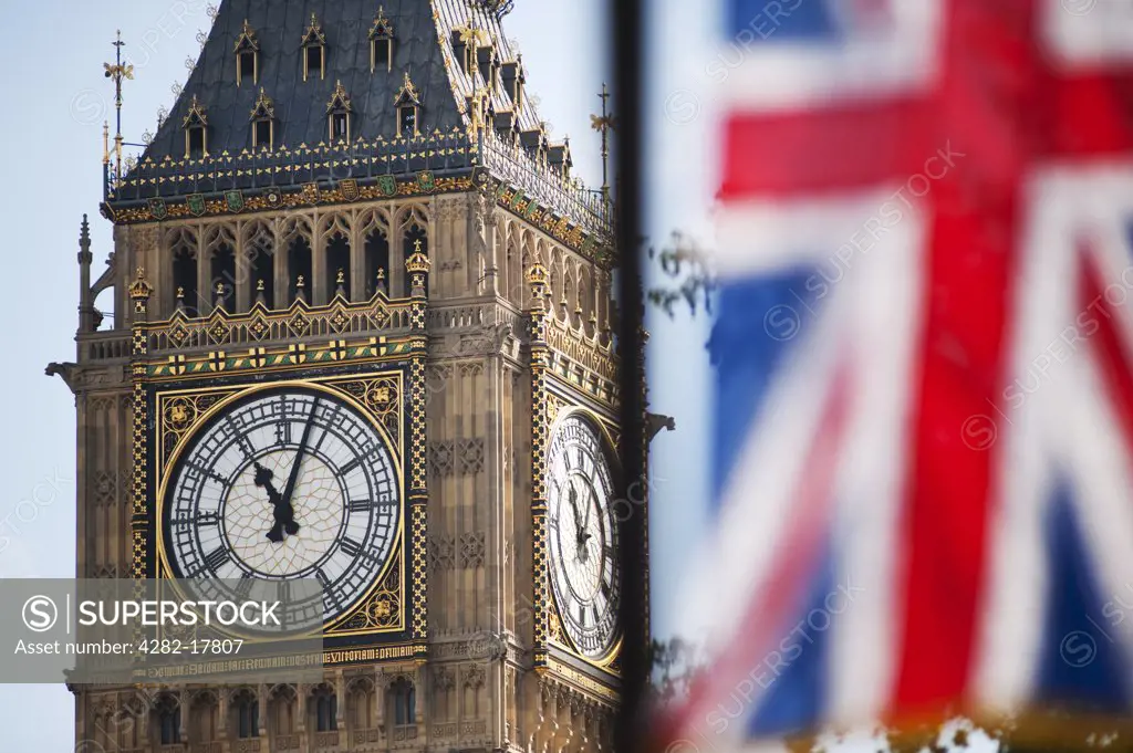 England, London, Westminster. Union Flag hanging on the Royal Wedding route in London's Parliament Square with the iconic clockface of Big Ben in the background.