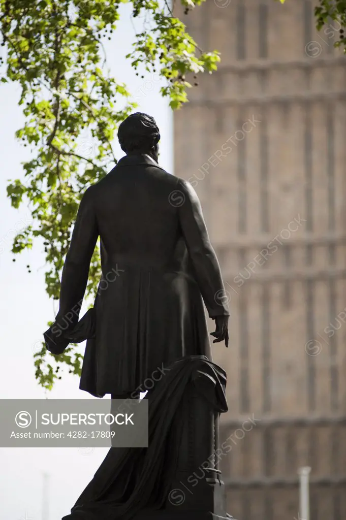 England, London, Westminster. Statue of Robert Peel in Parliament Square, central London, with the iconic clocktower of Big Ben in the background.