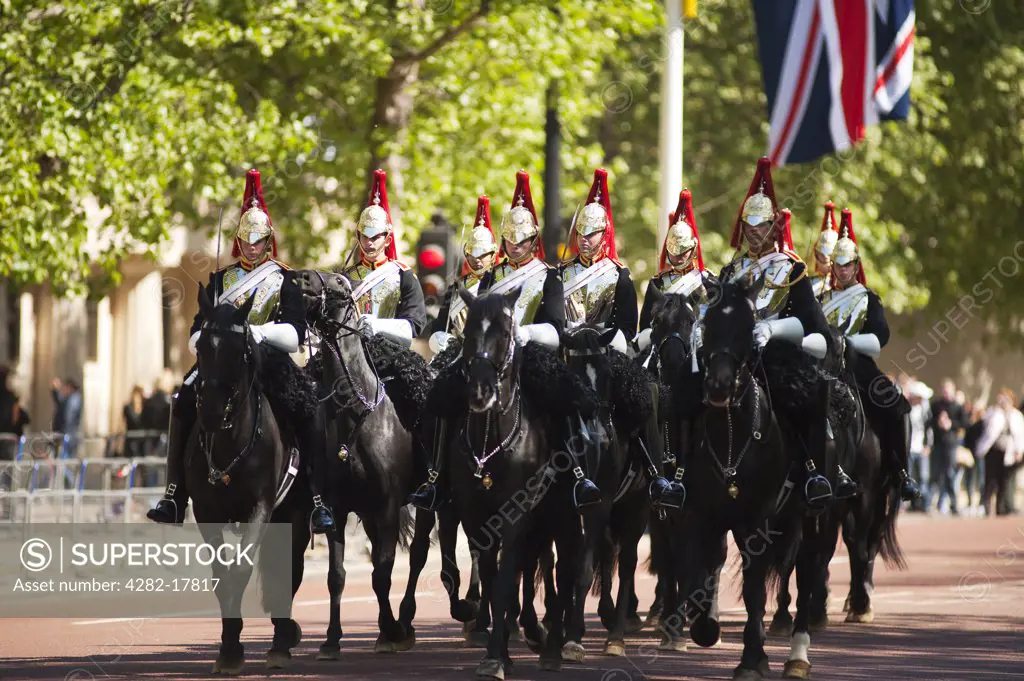 England, London, The Mall. Guards of the Blues and Royals troop down The Mall, decorated in large Union flags for the Royal Wedding between Prince William and Catherine Middleton.
