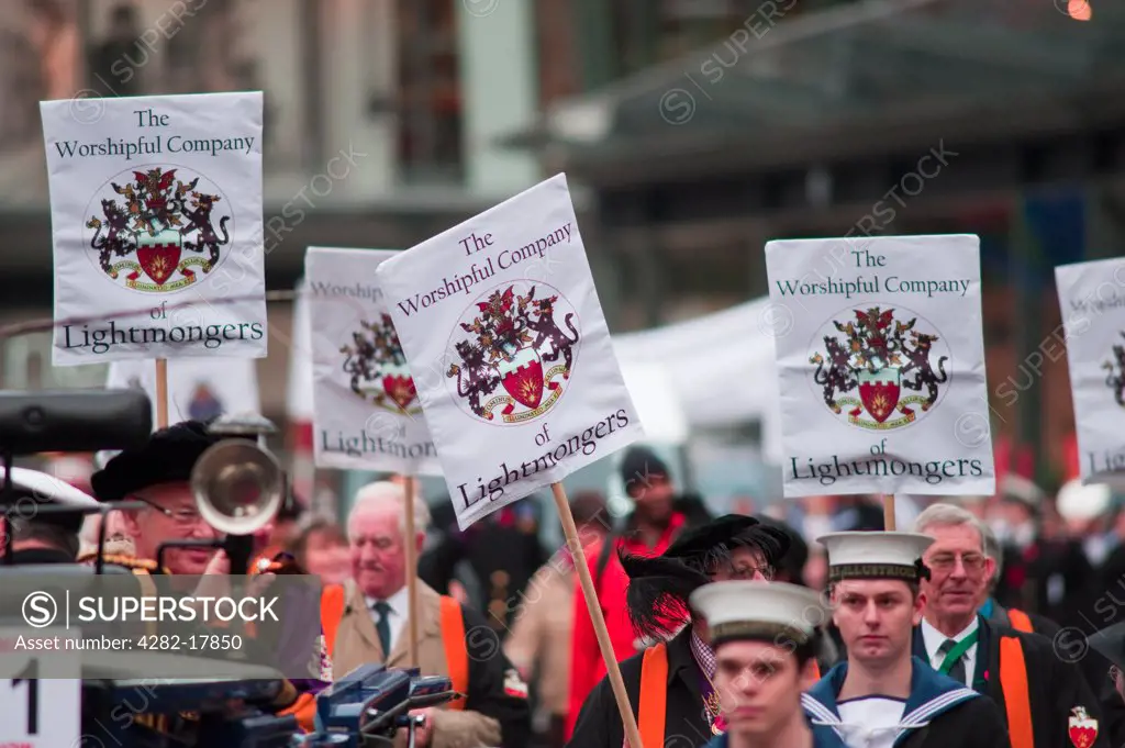 England, London, City of London. The Worshipful Company of Lightmongers, representing the electric lighting industry, and Royal Navy representatives from HMS Illustrious parading in the procession at the Lord Mayor's Show in the City of London.
