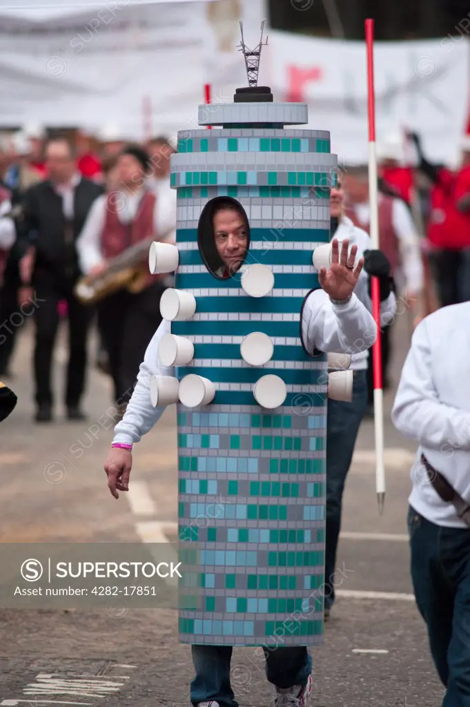 England, London, City of London. A man from the The Worshipful Company of Chartered Surveyors float dressed as the Post Office Tower in the procession at the Lord Mayor's Show in the City of London.
