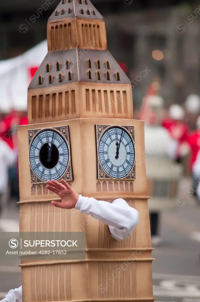 England, London, City of London. A person from the The Worshipful Company of Chartered Surveyors float dressed as Big Ben in the procession at the Lord Mayor's Show in the City of London.