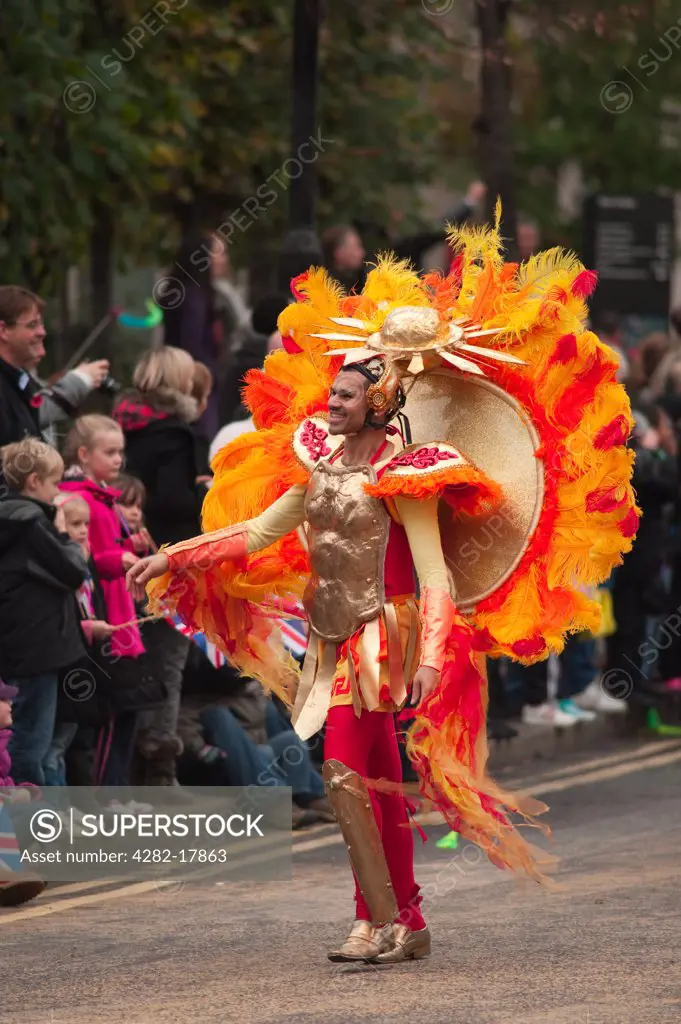 England, London, City of London. A member of the London School of Samba wearing a costume based on a theme of Gods, Myths and Monsters, in the procession at the annual Lord Mayor's Show in the City of London.
