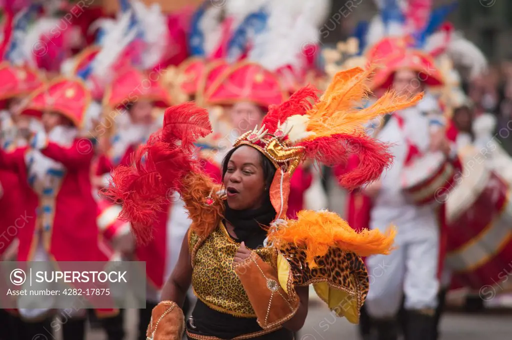 England, London, City of London. A woman wearing a colourful costume in the parade at the annual Lord Mayor's Show in the City of London.