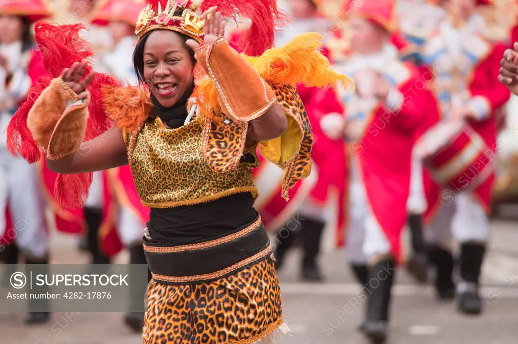England, London, City of London. A woman wearing a colourful costume in the parade at the annual Lord Mayor's Show in the City of London.