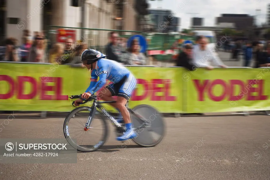 England, London, Westminster. UnitedHealthcare Pro Cycling Team cyclist speeding towards the finishing line in Whitehall during the Tour of Britain Stage 8a Time Trial in central London.