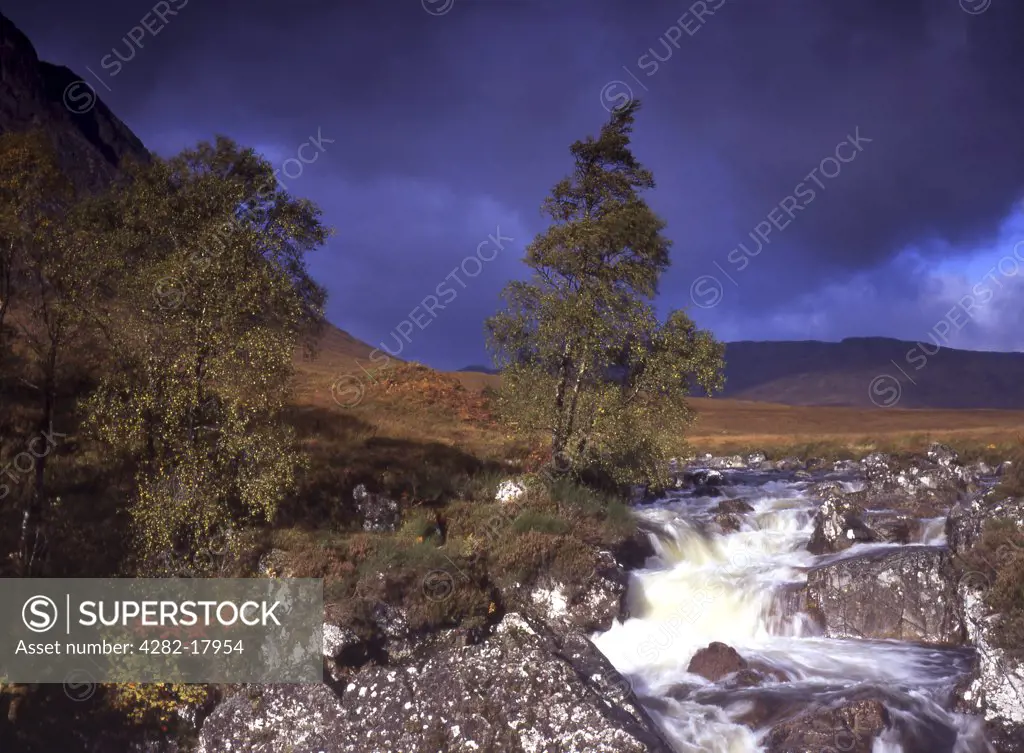 Scotland, Highland, Fort William. View of waterfall at the base of The Buchaille in stormy weather.