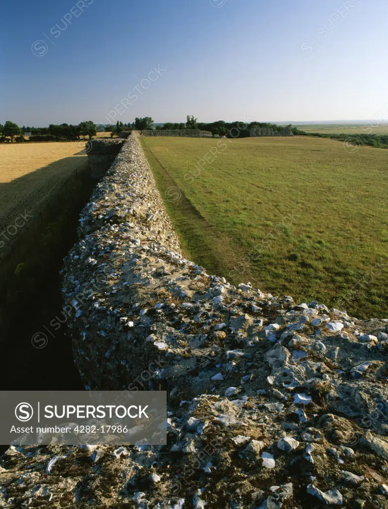 England, Norfolk, Burgh Castle. Looking from the NE corner tower along the southern wall and projecting bastions of Burgh Castle Roman Fort, a rectangular fort built by the Romans in the 3rd century AD against Saxon raiders.