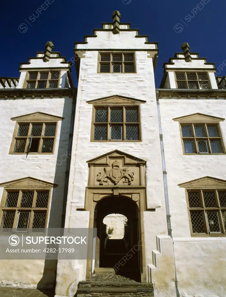 Wales, Conwy, Conwy. Looking up from High Street at the gatehouse to Plas Mawr (Great Hall), probably the best preserved Elizabethan townhouse in Britain. Completed 1585 for Robert Wynn whose arms are above the entrance passage.