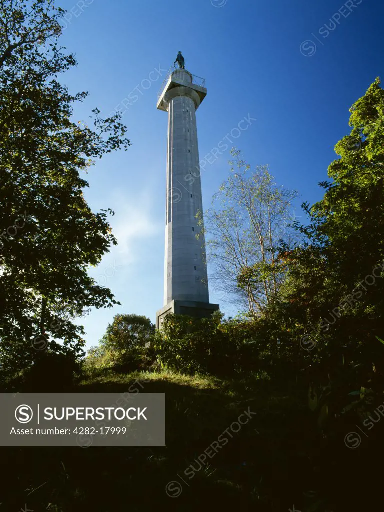 Wales, Anglesey, Llanfair Pwllgwyngyll. The Marquess of Anglesey's Column rising from the rock outcrop of Craig y Dinas erected 1816-7. The bronze figure of the Marquess in hussar uniform was added in 1860.