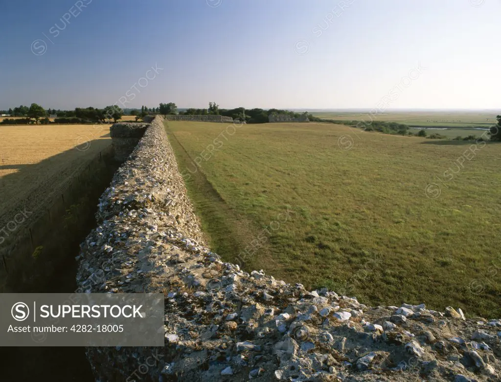 England, Norfolk, Burgh Castle. Looking from the NE corner tower along the southern wall and projecting bastions of a rectangular fort built by the Romans in the 3rd century AD against Saxon raiders.
