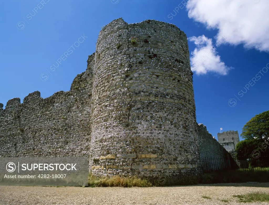 England, Hampshire, Portchester. North East corner bastion of the Roman fort (Portus Adurni) with the rectangular keep of the Norman castle to the rear.