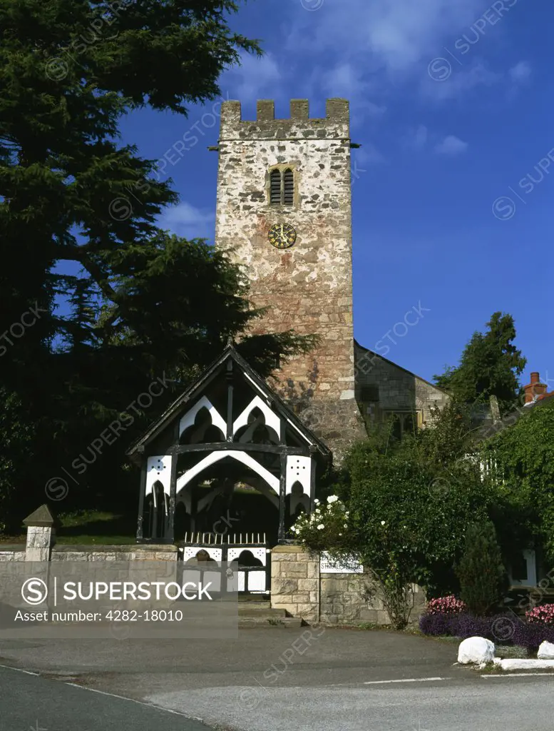 Wales, Denbighshire, Bodfari. The Perpendicular tower and timber-framed lychgate of St Stephen's Church.