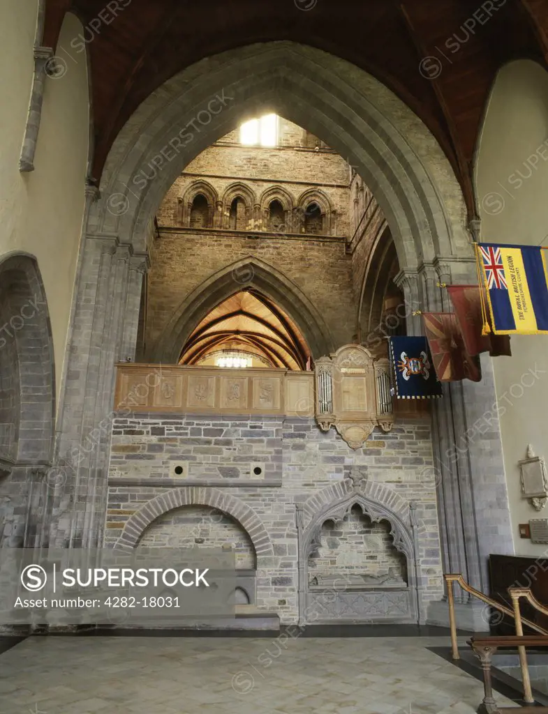 Wales, Pembrokeshire, St David's. St Caradoc's shrine (left) in the south wall of the North Transept of St David's Cathedral. To the rear is the tower with choir below, to the right the tomb of an unknown bishop and the County of Pembroke War Memorial to those who lost their lives in 1939-45.