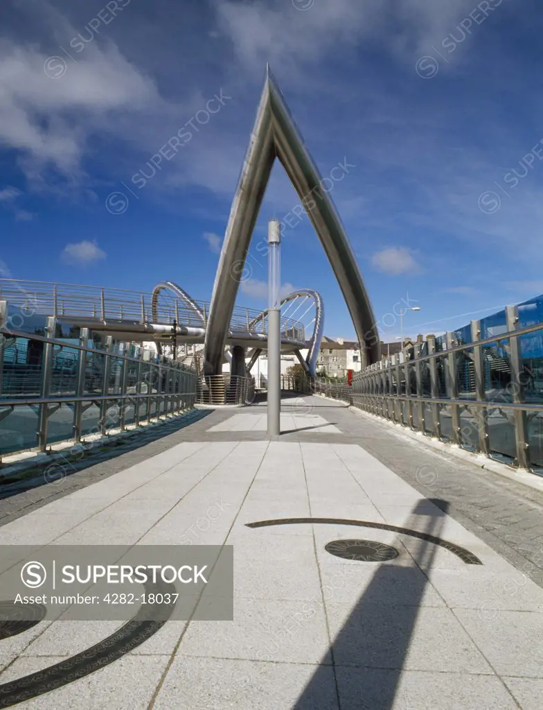 Wales, Anglesey, Holyhead. The main walkway and stainless steel arch of the Celtic Gateway bridge, opened 19 October 2006, linking the ferry terminal and railway station to the town centre across the Inner Harbour.