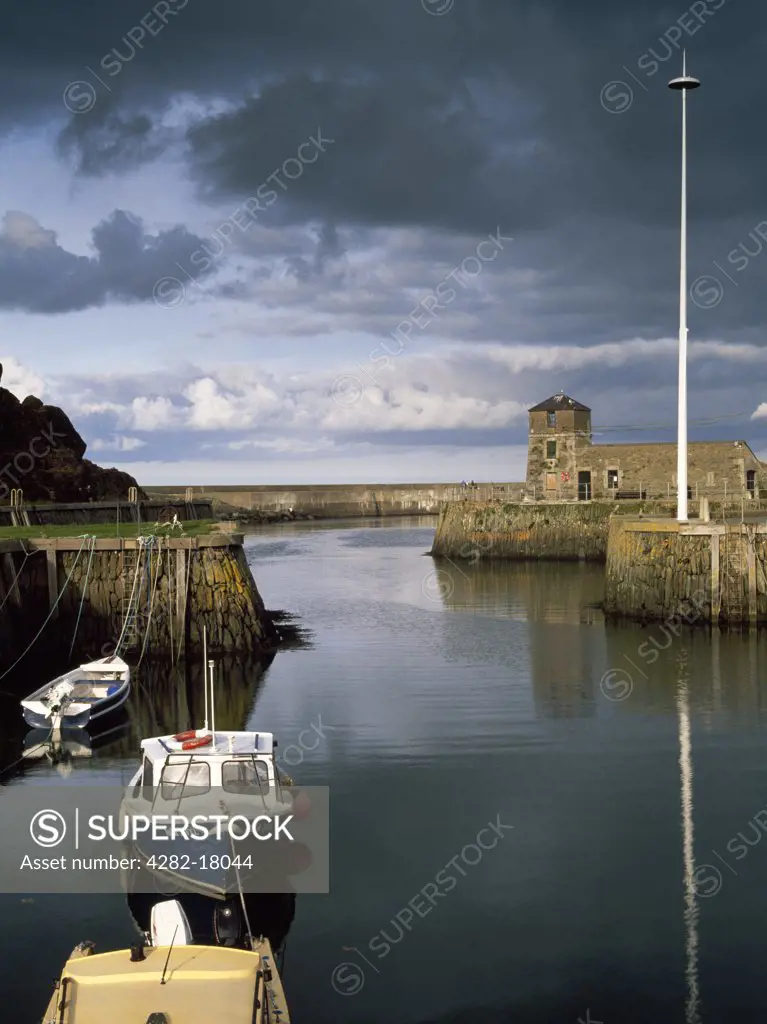 Wales, Anglesey, Amlwch Port. Amlwch Port was the harbour for the Parys Mountain copper mines. The pier on the right, built in 1816, enabled some forty vessels to shelter in the port behind wooden beams sealing the entrance. The Watch House was added in 1819.