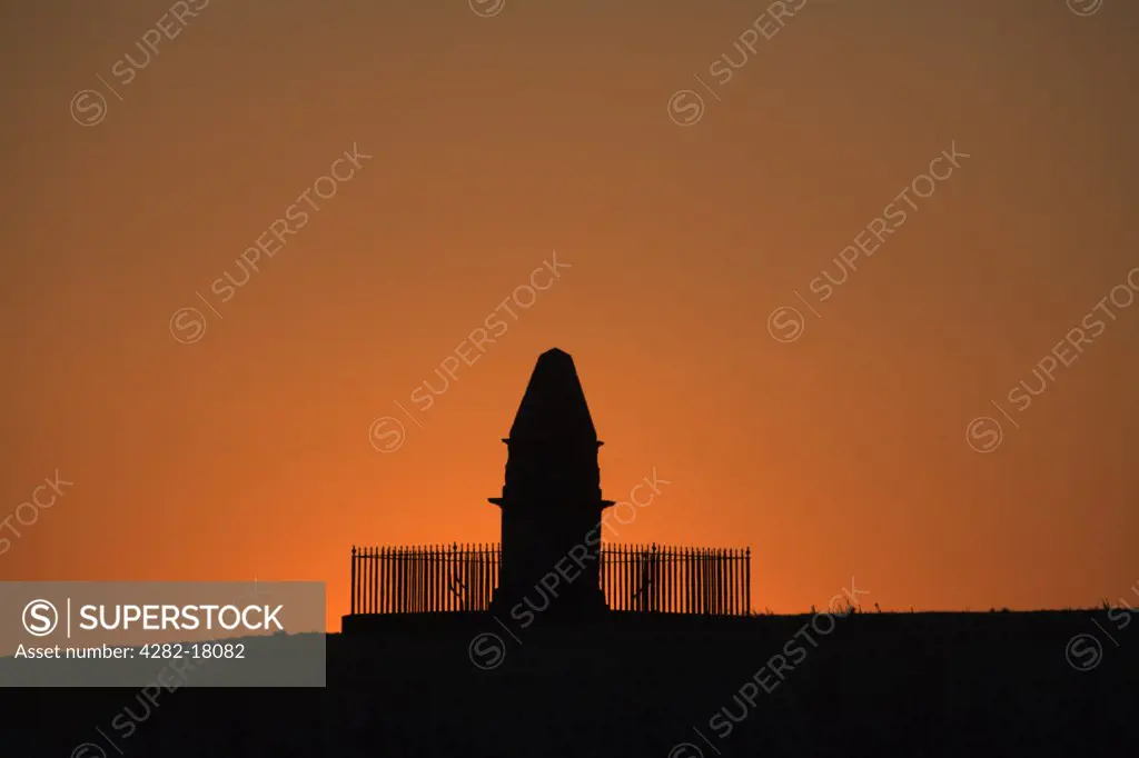 England, Somerset, East Lyng. Silhouette of King Alfred's monument on the Isle of Athelney at sunrise.