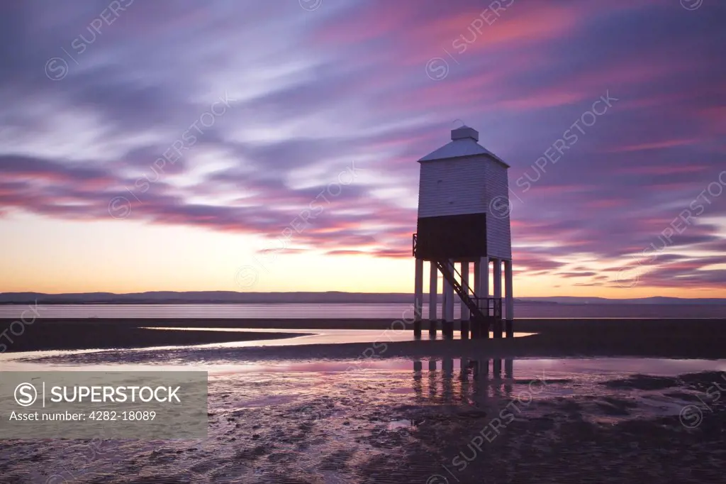 England, Somerset, Burnham-on-Sea. The low wooden pile lighthouse (Lighthouse on legs) at sunset.