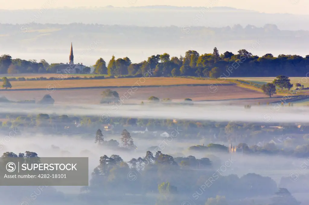 England, Somerset, Glastonbury. View over Glastonbury from Glastonbury Tor on a misty morning just after sunrise.