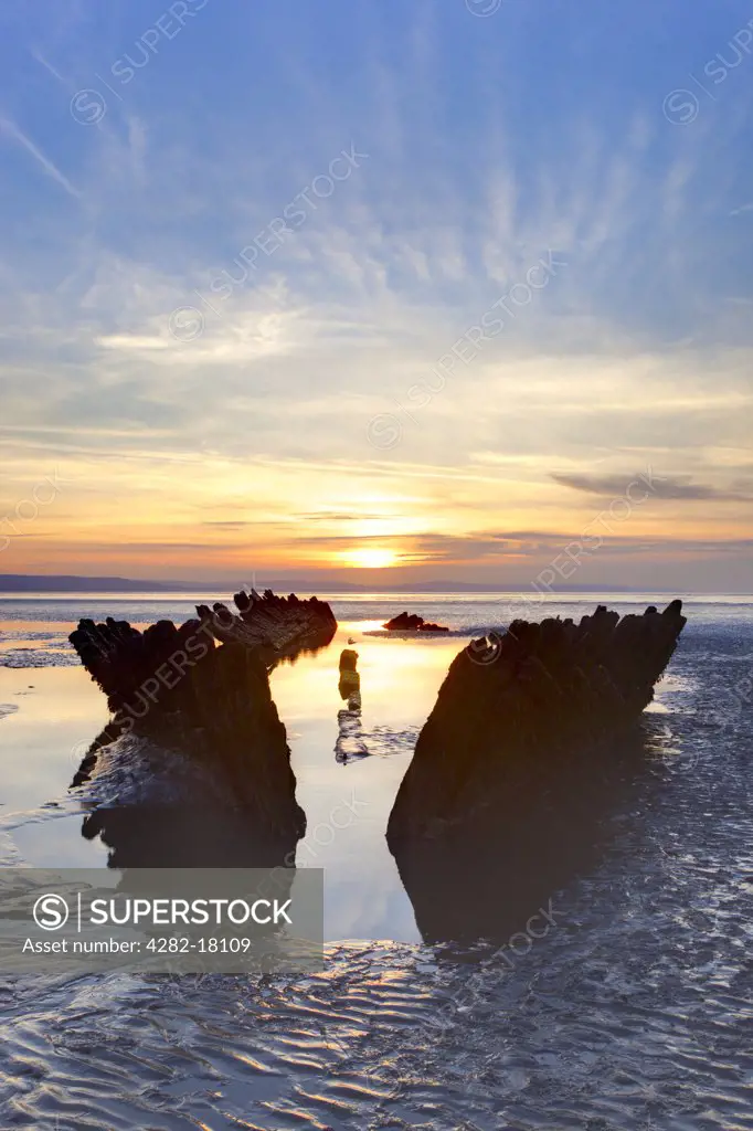 England, Somerset, Burnham-On-Sea. Sunset behind the wreck of the Norwegian barque SS Nornen which ran aground on 3rd March 1897.