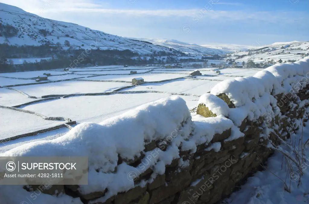 England, North Yorkshire, Gunnerside. Snow covered fields and dry stone walls in Swaledale near Gunnerside.