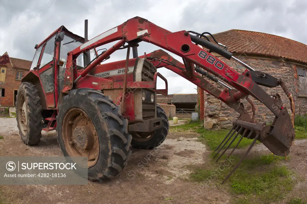 England, Somerset, Taunton. A tractor parked in a farmyard.