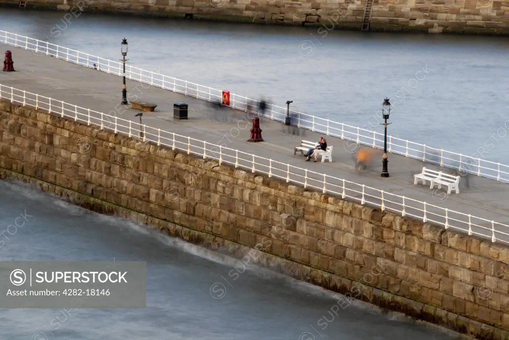 England, North Yorkshire, Whitby Pier. People on Whitby Pier.