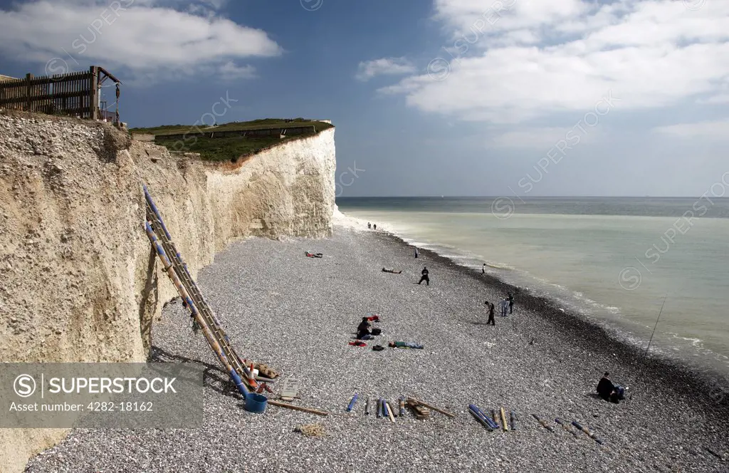 England, East Sussex, Birling Gap. A view along the beach toward the Seven Sisters chalk cliff formation.