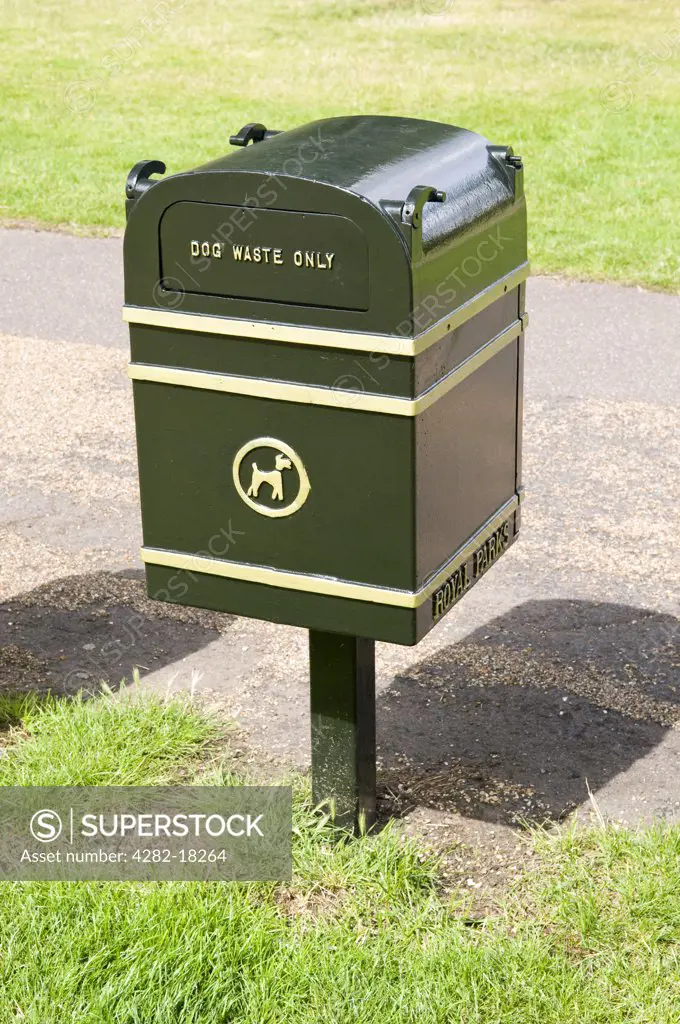 England, London, Hyde Park. Close up of a green dog waste bin in Hyde Park.