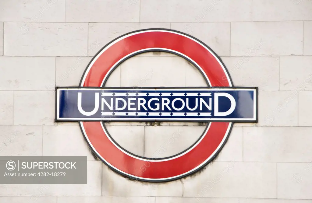 England, London, Charing Cross. London Underground sign and logo fixed on a wall in London.