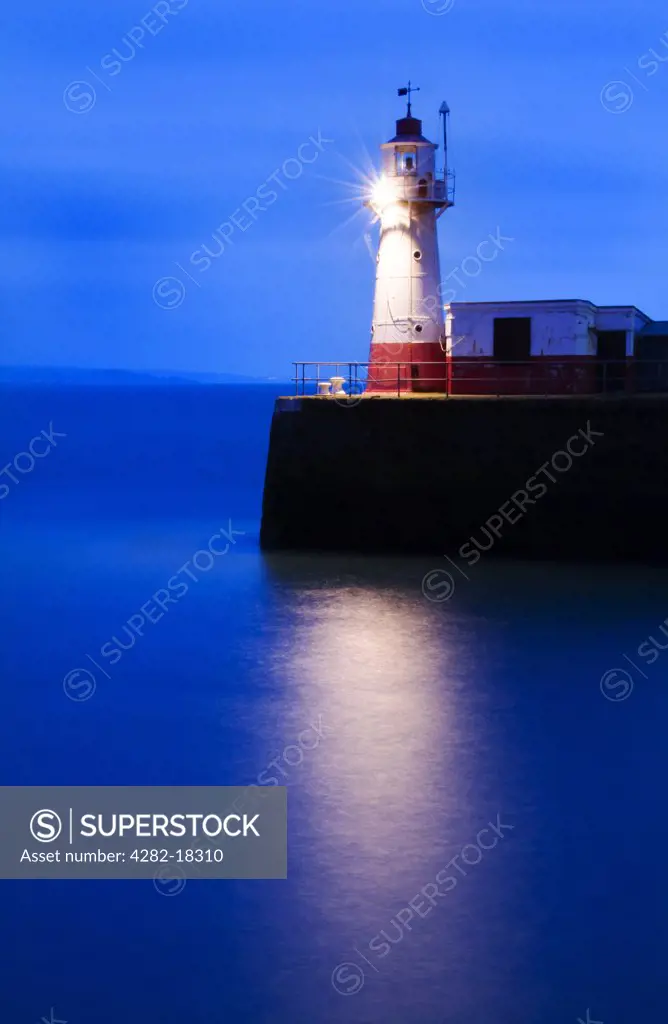 England, Cornwall, Newlyn. The Lighthouse at the end of the Newlyn Pier at dawn.