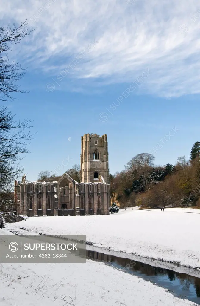 England, North Yorkshire, Fountains Abbey. Snow covering the ground around the 12th century ruins of Fountains Abbey, the largest monastic ruins in England.