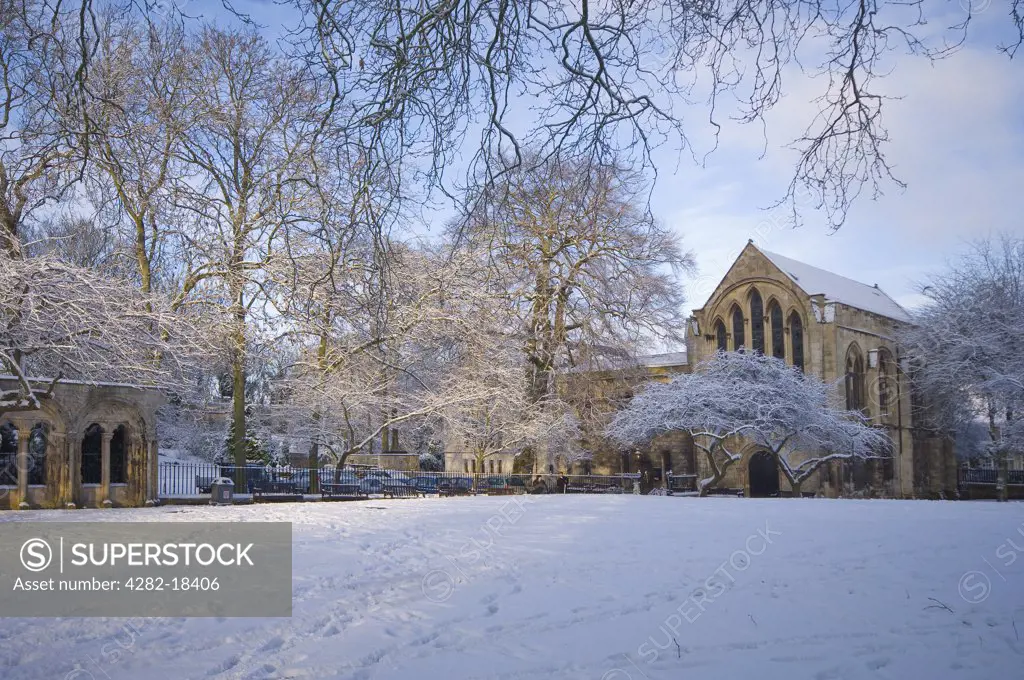 England, North Yorkshire, York. York Minster Library (1230), the largest cathedral library in England, viewed from the snow covered grounds of Deans Park.