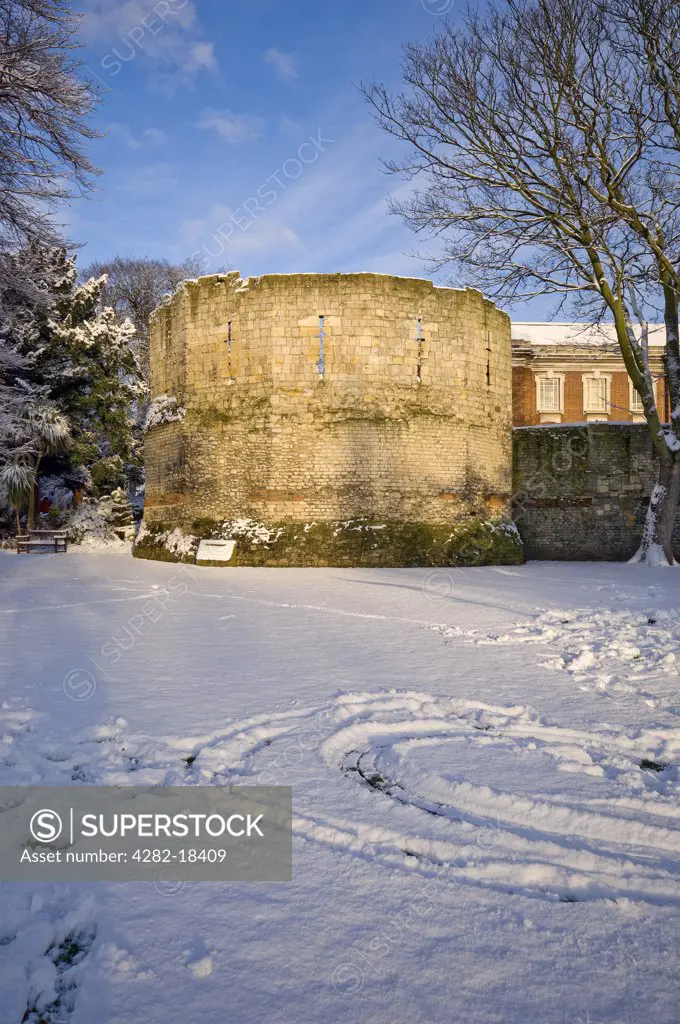 England, North Yorkshire, York. The snow covered Roman-built Multangular Tower in the Yorkshire Museum Gardens in the centre of York.